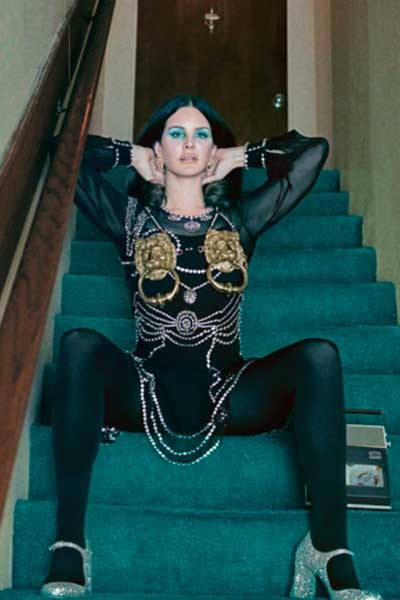 Traje de chifón de seda con cristalería Swarovski y top con ondas en metal color dorado de MOSCHINO, medias CALZEDONIA, zapatos MIU MIU y aretes GUCCI.